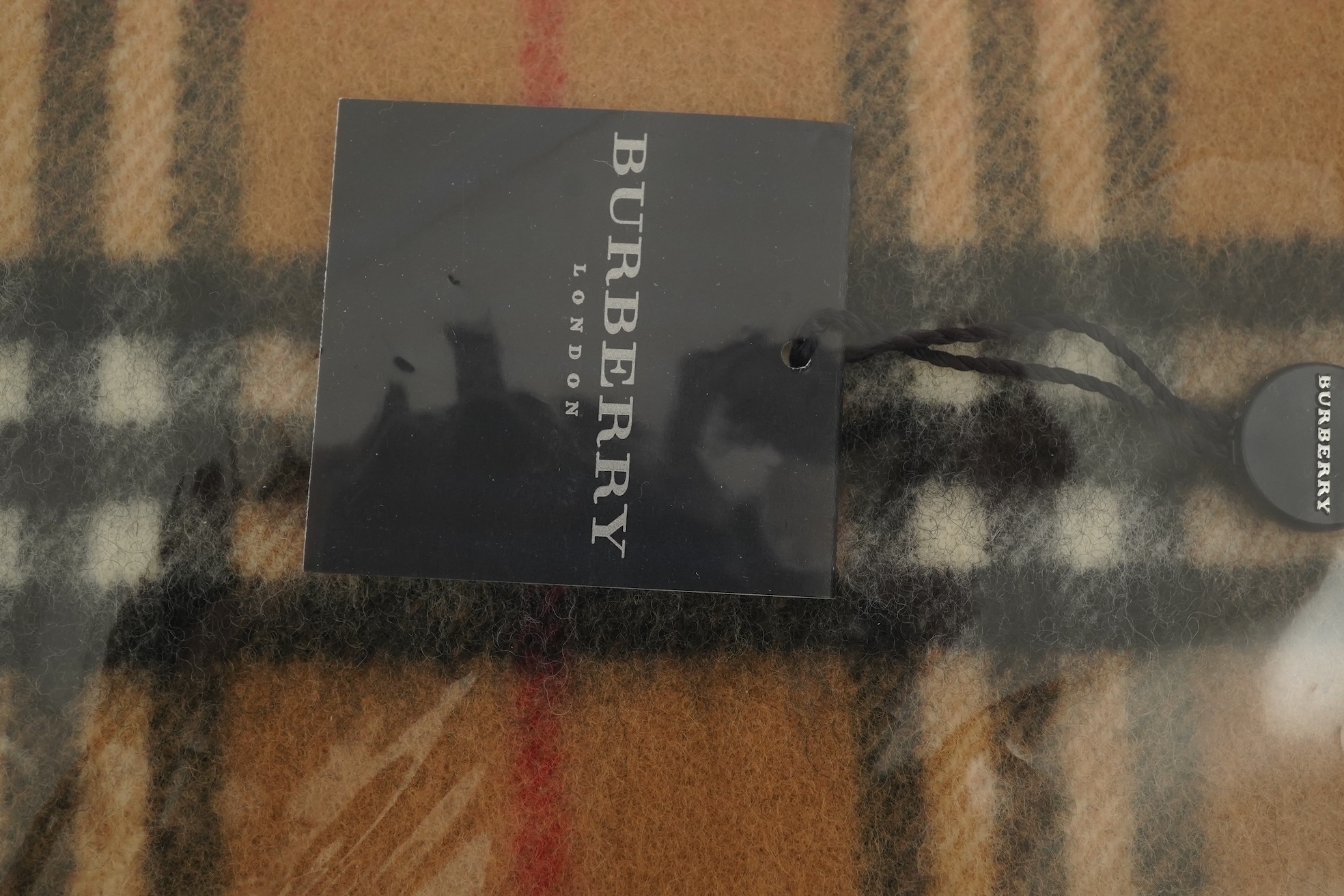 A Burberry brown tartan scarf, sunglasses with case and wallet with original box.